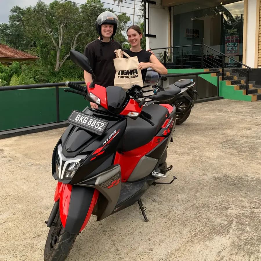 Customers with their NOHA scooter at handover